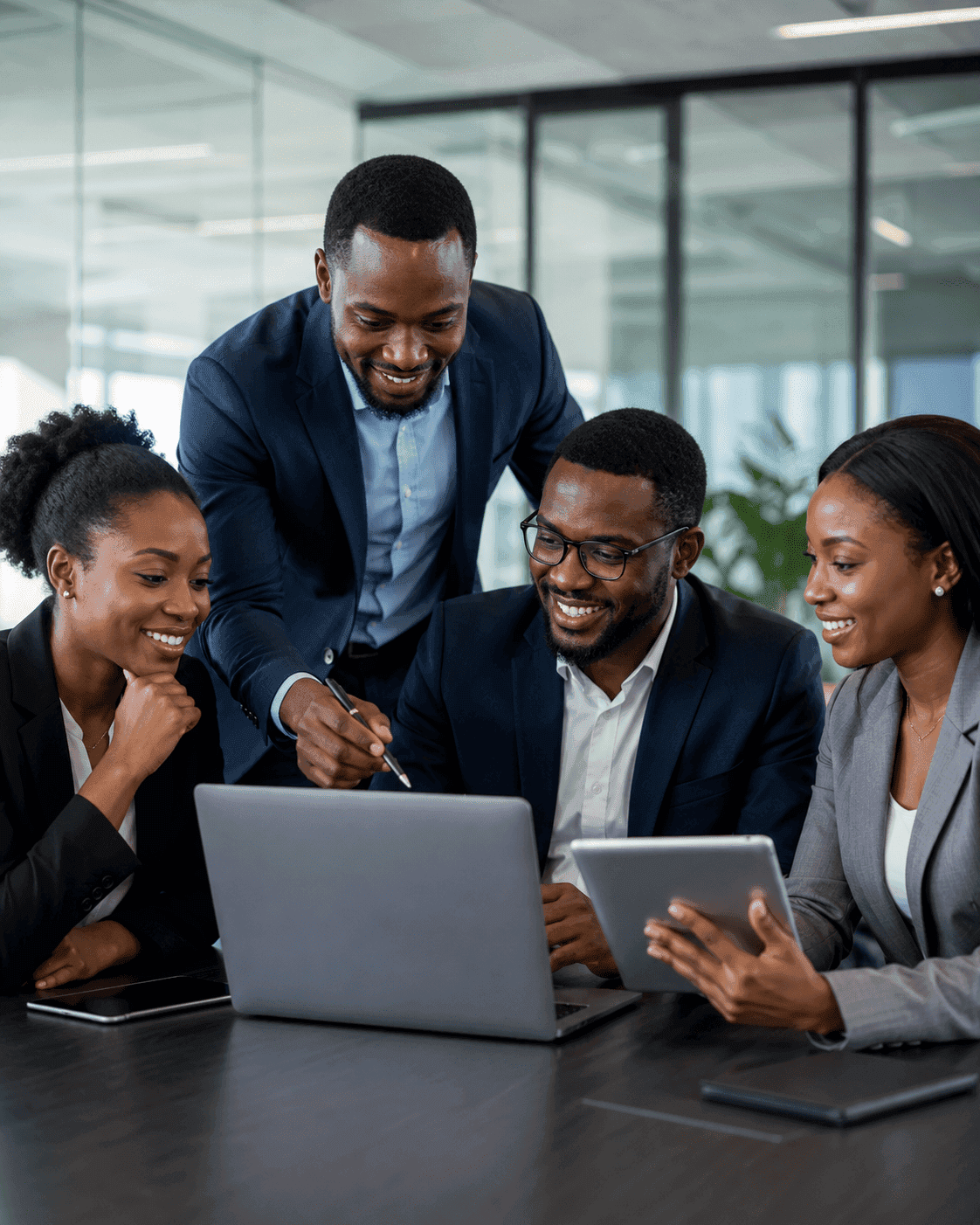Technology professionals collaborating around a laptop