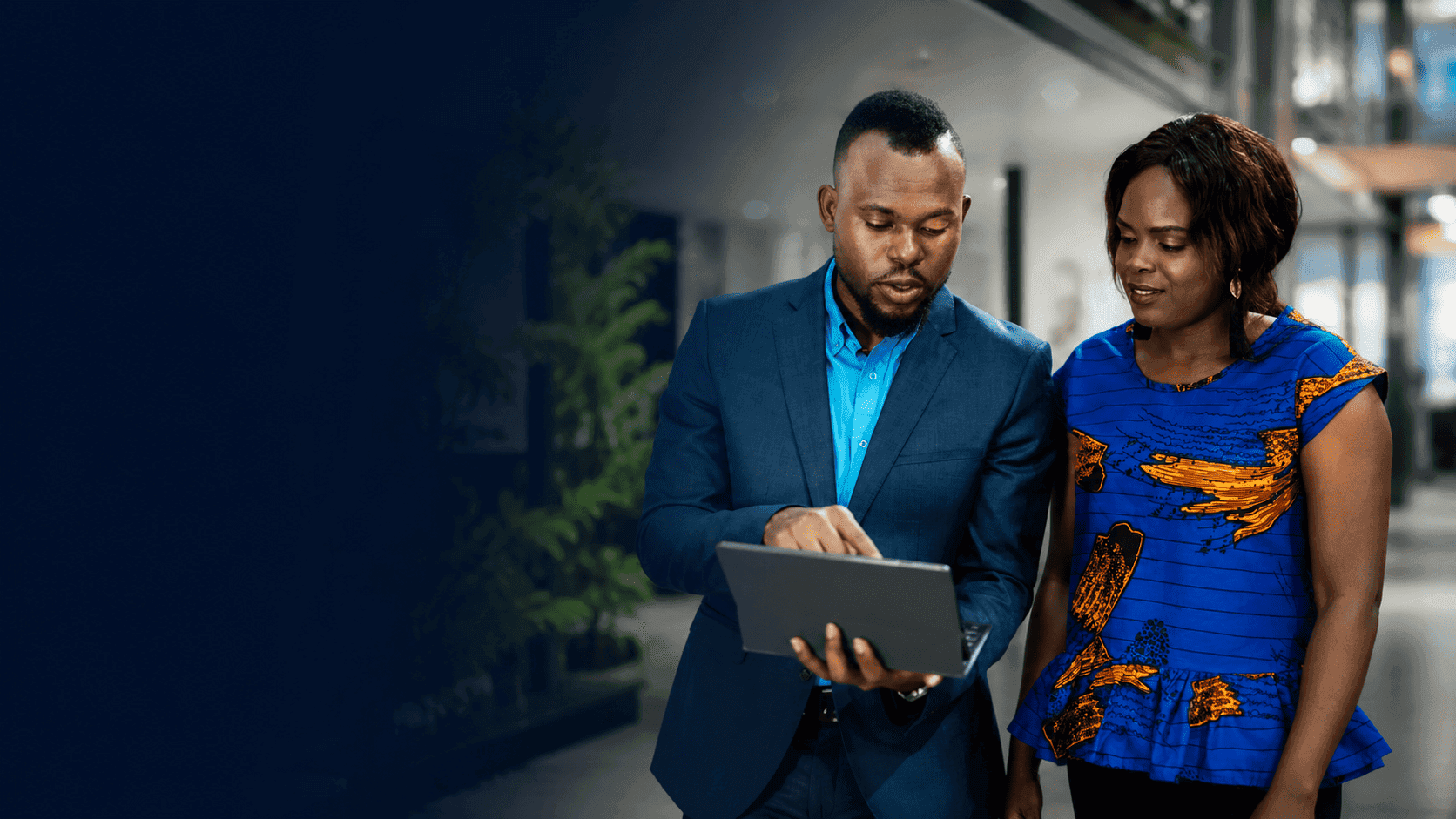 Technology consultants reviewing a solution on a digital tablet